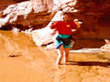 Joan sinking in the quicksand of Forbidding Canyon